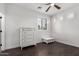 Bedroom with hardwood floors, white trim and furniture, and three bright windows at 823 W Palo Verde Dr, Phoenix, AZ 85013