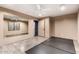 Neutral bedroom with ceiling fan, light gray floors, large mirror and doorway to bathroom at 823 W Palo Verde Dr, Phoenix, AZ 85013