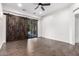 The primary bedroom features hardwood floors, ceiling fan, and a dark wood sliding barn door leading to the backyard at 823 W Palo Verde Dr, Phoenix, AZ 85013