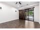 The primary bedroom offers hardwood floors, ceiling fan, and a dark wood sliding barn door to the backyard and pool at 823 W Palo Verde Dr, Phoenix, AZ 85013