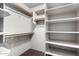 Walk-in closet with built in shelving and light wood closet rods at 823 W Palo Verde Dr, Phoenix, AZ 85013