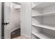 Hallway and storage features with pristine, white shelving at 823 W Palo Verde Dr, Phoenix, AZ 85013