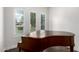 Bright living room with an upright piano and large windows that offer natural light and street views at 823 W Palo Verde Dr, Phoenix, AZ 85013