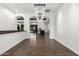 Open-concept living area with hardwood floors, white walls, and decorative lighting at 823 W Palo Verde Dr, Phoenix, AZ 85013