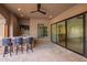 Outdoor kitchen features a built-in bar, seating, and retractable glass doors to the home's interior at 823 W Palo Verde Dr, Phoenix, AZ 85013