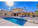 Expansive backyard pool featuring a diving board, outdoor seating, built-in grill, and manicured patio at 823 W Palo Verde Dr, Phoenix, AZ 85013