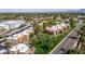 Aerial view showcasing the apartments, landscaped grounds, and proximity to nearby shopping centers and tree-lined streets at 8256 E Arabian Trl # 239, Scottsdale, AZ 85258