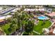 Aerial shot of an apartment complex with lush landscaping, mature palm trees, inviting pool, and convenient parking areas at 8256 E Arabian Trl # 239, Scottsdale, AZ 85258