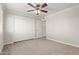 This bedroom features wood-look floors, a ceiling fan, and a closet at 8256 E Arabian Trl # 239, Scottsdale, AZ 85258