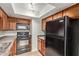 This kitchen features wood cabinets, tile floor, and stainless appliances at 8256 E Arabian Trl # 239, Scottsdale, AZ 85258
