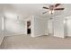 Living room with wood-look floors next to kitchen with black appliances at 8256 E Arabian Trl # 239, Scottsdale, AZ 85258