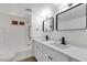 Bright bathroom featuring a double sink vanity, modern fixtures, and a shower over the tub at 848 W Calle Del Norte --, Chandler, AZ 85225