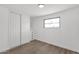 This bedroom features a closet, a built-in set of drawers, wood-look flooring and a window at 848 W Calle Del Norte --, Chandler, AZ 85225