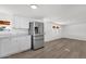 Bright kitchen featuring stainless steel appliances, white cabinets, and wood-look floors at 848 W Calle Del Norte --, Chandler, AZ 85225