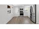 Bright kitchen featuring stainless steel appliances, white cabinets, and wood-look floors at 848 W Calle Del Norte --, Chandler, AZ 85225