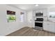 Bright kitchen featuring stainless steel appliances, white cabinets, and wood-look floors at 848 W Calle Del Norte --, Chandler, AZ 85225
