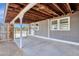 This patio is covered with exposed beams and concrete flooring with a view of a fenced yard at 848 W Calle Del Norte --, Chandler, AZ 85225