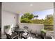 Relaxing balcony area with an ornate metal table set, offering a serene outdoor space with leafy green views at 902 W Glendale Ave # 215, Phoenix, AZ 85021