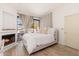 Sunlit bedroom featuring a cozy fireplace and a large window providing an inviting and peaceful space at 902 W Glendale Ave # 215, Phoenix, AZ 85021