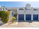 Stylish condo complex showcasing a well-maintained building with colorful landscaping and blue garage doors at 902 W Glendale Ave # 215, Phoenix, AZ 85021