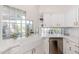 Well-lit kitchen with white cabinetry, stainless steel appliances, and a charming farmhouse sink at 902 W Glendale Ave # 215, Phoenix, AZ 85021