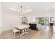 Elegant living room featuring light wood floors, a chandelier, and a cozy fireplace at 902 W Glendale Ave # 215, Phoenix, AZ 85021
