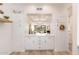 Charming view into the living room through an opening, complemented by white cabinets and gold hardware at 902 W Glendale Ave # 215, Phoenix, AZ 85021