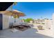 Inviting outdoor patio furnished with a comfortable sectional, a fire pit, and a parasol for relaxed gatherings at 902 W Glendale Ave # 215, Phoenix, AZ 85021