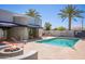 Outdoor pool area featuring lounge chairs, a fire pit, and ample space for relaxation at 902 W Glendale Ave # 215, Phoenix, AZ 85021