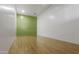 Empty racquetball court featuring wooden floors, a green back wall, and white side walls at 902 W Glendale Ave # 215, Phoenix, AZ 85021