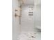 Luxurious glass-enclosed shower featuring a rainfall shower head and a tiled niche for storing toiletries at 902 W Glendale Ave # 215, Phoenix, AZ 85021