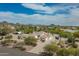 Expansive aerial view showcasing the desert property, surrounding mountains, and lush landscaping at 9053 N 123Rd St, Scottsdale, AZ 85259