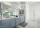 Beautiful bathroom with marble floors, double sink vanity with blue cabinets, and walk-in shower at 9053 N 123Rd St, Scottsdale, AZ 85259