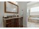 Well-lit bathroom features a vanity with granite countertop and a separate tub and shower at 9053 N 123Rd St, Scottsdale, AZ 85259