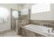 Bathroom featuring a jetted tub and a glass enclosed shower at 9053 N 123Rd St, Scottsdale, AZ 85259