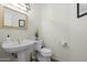 Bathroom featuring a pedestal sink and elongated toilet at 9053 N 123Rd St, Scottsdale, AZ 85259