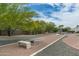 Backyard horseshoe pit with horseshoe and benches; gravel landscaping and mature trees at 9053 N 123Rd St, Scottsdale, AZ 85259