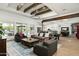 Open-concept living area with beamed ceilings, a large area rug, and comfortable seating arrangements at 9053 N 123Rd St, Scottsdale, AZ 85259