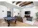 Spacious living room with a pool table, modern lighting, and seamless flow to adjacent areas at 9053 N 123Rd St, Scottsdale, AZ 85259