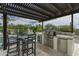 Outdoor kitchen with stainless steel grill and bar seating, perfect for entertaining at 9053 N 123Rd St, Scottsdale, AZ 85259