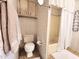 Cozy bathroom with floral wallpaper, vanity, toilet, shower, and decorative towels at 9333 E University Dr # 184, Mesa, AZ 85207