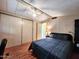 Bedroom with ceiling fan, closet, and wood-look floors, offering a cozy retreat at 9333 E University Dr # 184, Mesa, AZ 85207
