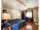 Bedroom featuring a comfortable bed, ceiling fan, desk, and wood laminate flooring at 9333 E University Dr # 184, Mesa, AZ 85207