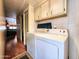 Laundry room with appliances, storage cabinets, and easy access to the living areas at 9333 E University Dr # 184, Mesa, AZ 85207