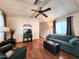 Comfortable living room with stylish furnishings, including a plush sofa, accent chairs, and a ceiling fan at 9333 E University Dr # 184, Mesa, AZ 85207