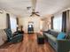 Inviting living room featuring hardwood floors, a comfortable sofa, and cozy seating arrangements at 9333 E University Dr # 184, Mesa, AZ 85207