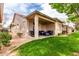 Exterior view of the backyard featuring the covered patio and furniture at 9717 E Holiday Way, Sun Lakes, AZ 85248