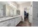Bright bathroom featuring dual sinks with granite counters and a walk-in closet at 9717 E Holiday Way, Sun Lakes, AZ 85248