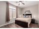 Cozy bedroom features a ceiling fan and dark wood furniture at 9717 E Holiday Way, Sun Lakes, AZ 85248