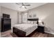 Bedroom with a ceiling fan, wooden floors, and artwork above the bed at 9717 E Holiday Way, Sun Lakes, AZ 85248